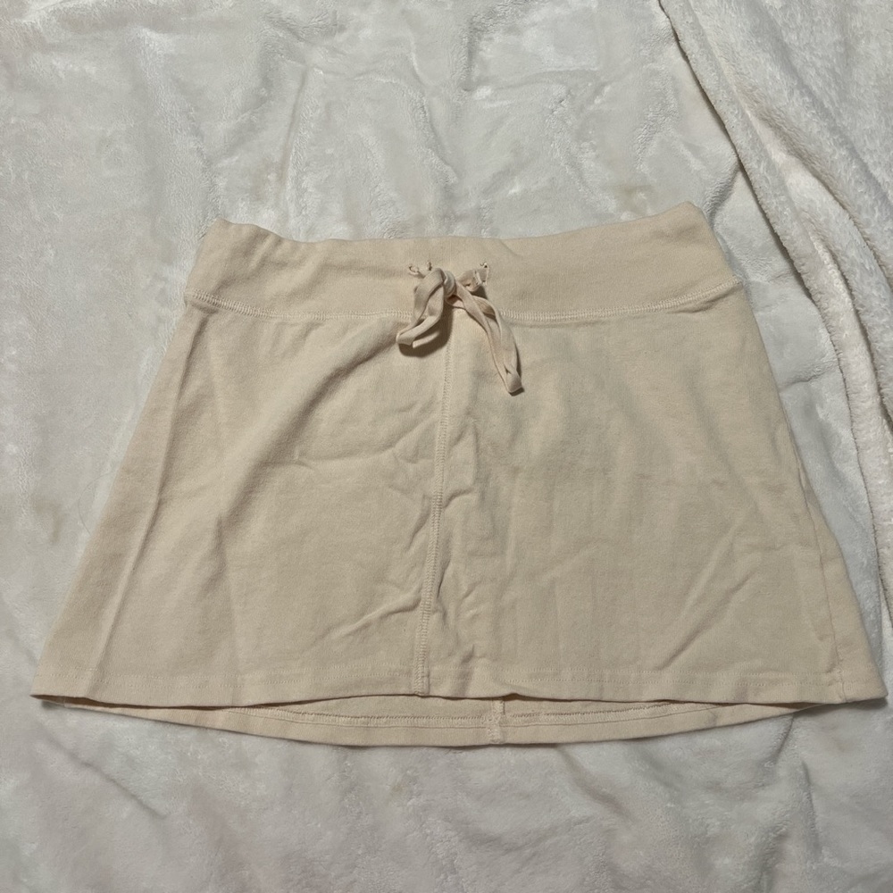 brandy melville cream mini skirt